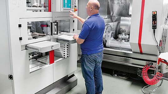 A Reliance Precision manufacturing engineer instigating movement of the pallet magazine to start an automated production run.